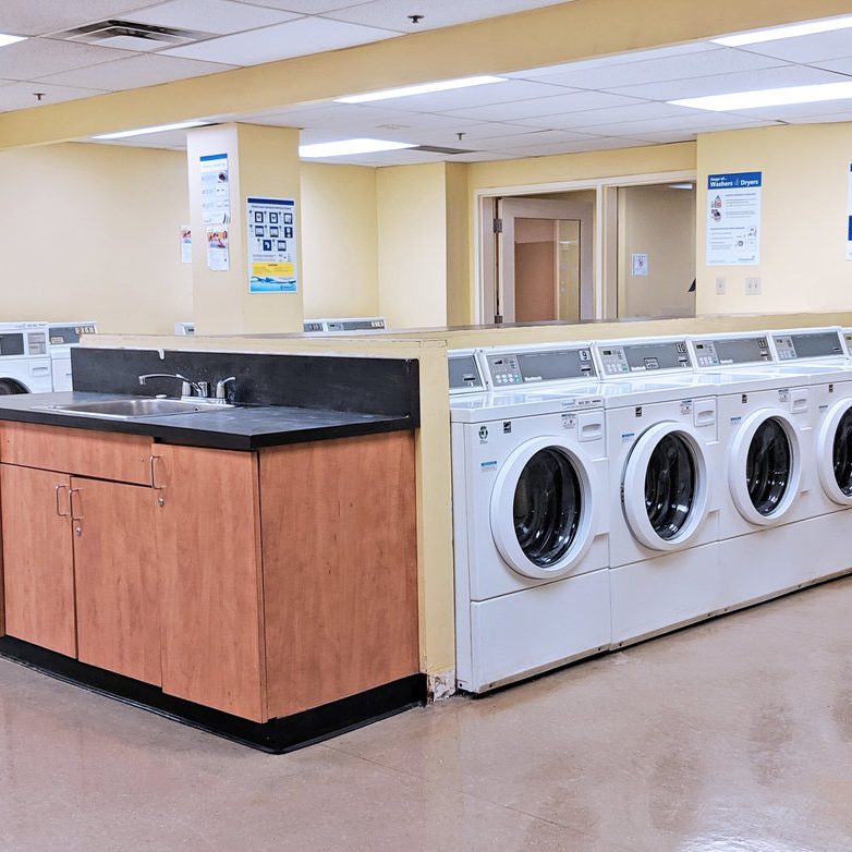 Laundry room with many washers and dryers